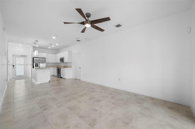 unfurnished living room featuring visible vents, baseboards, a ceiling fan, and recessed lighting