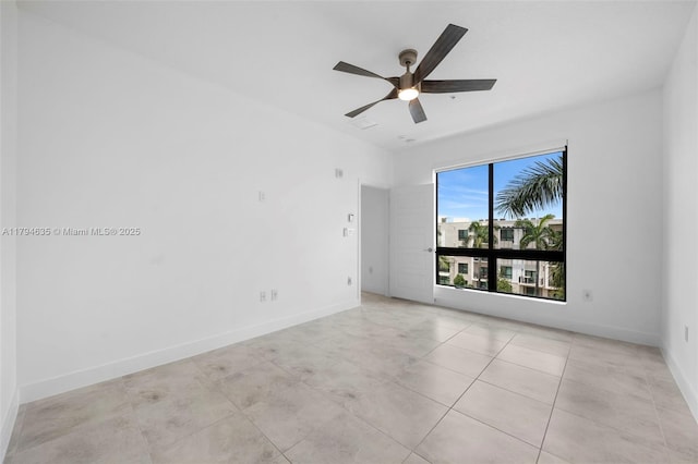 unfurnished room featuring baseboards, light tile patterned flooring, and ceiling fan
