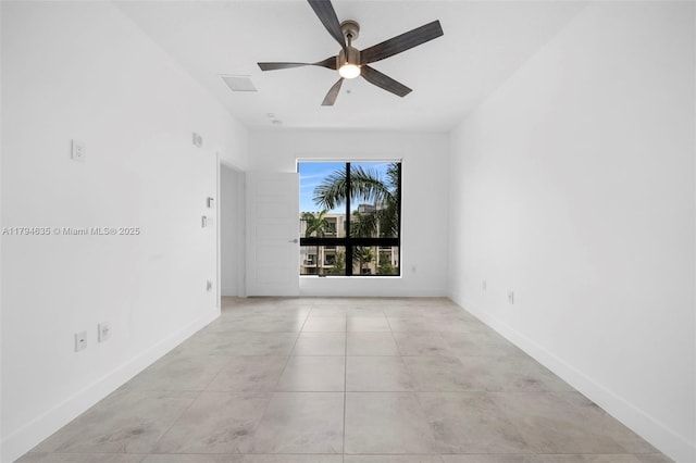 empty room featuring baseboards and a ceiling fan