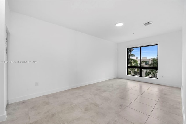 empty room featuring baseboards, recessed lighting, light tile patterned floors, and visible vents