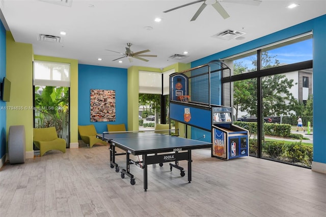 playroom with visible vents, ceiling fan, and wood finished floors
