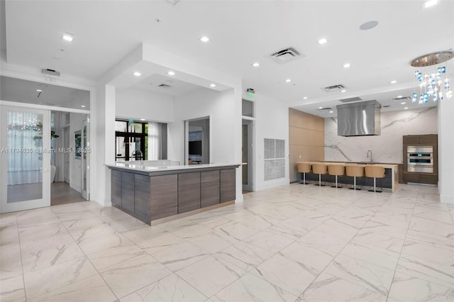 kitchen with marble finish floor, modern cabinets, and french doors