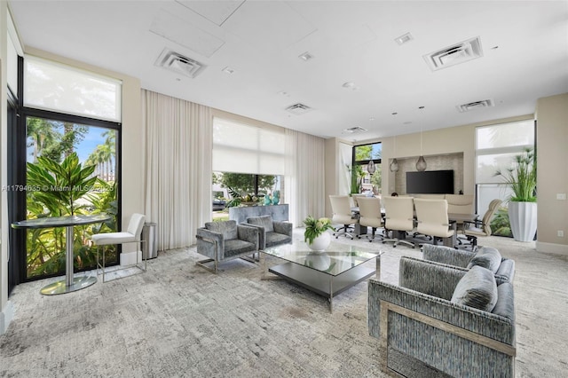 living area featuring visible vents and carpet