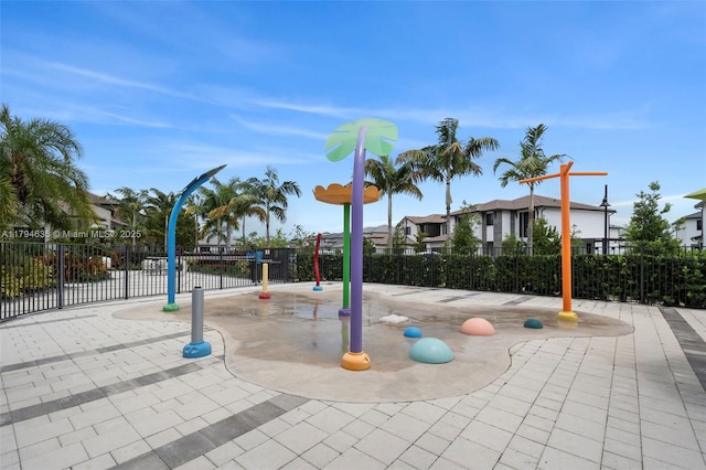 view of jungle gym with fence and a residential view