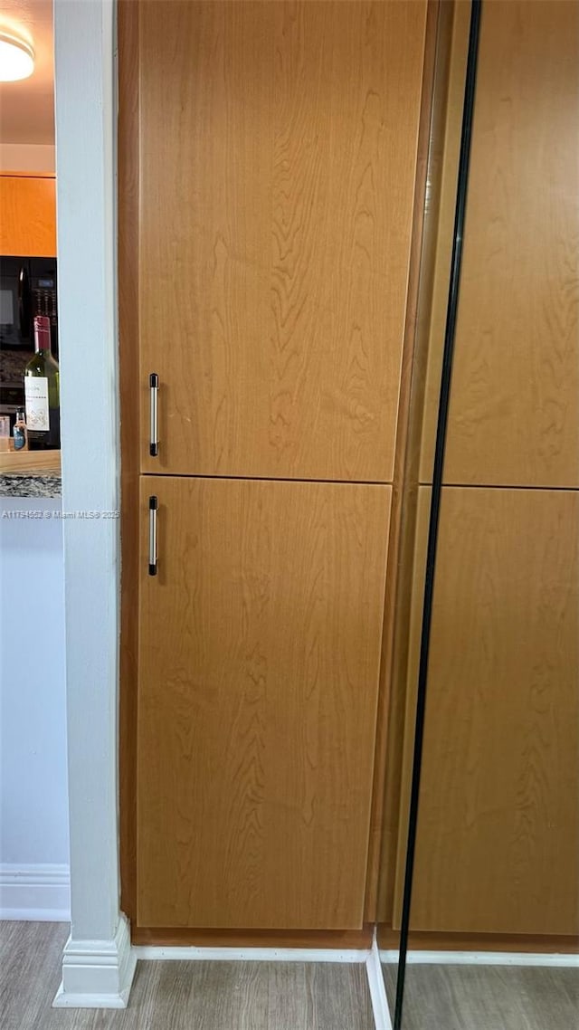details with baseboards and wood finished floors