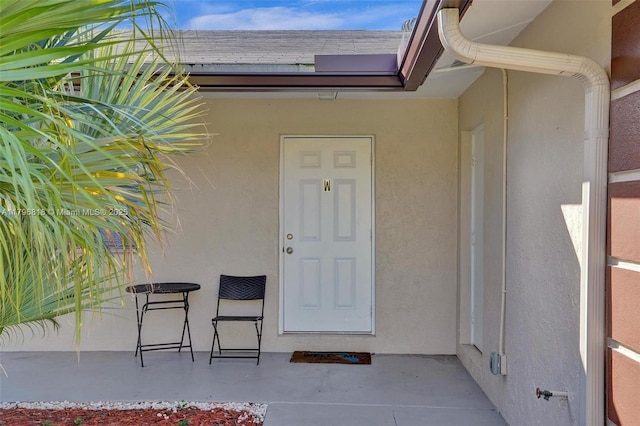 doorway to property with stucco siding
