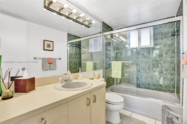 1000 NE 191st St Unit 21, Miami, FL 33179 - bathroom featuring toilet, a textured ceiling, tile patterned flooring, bath / shower combo with glass door, and vanity