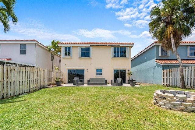 rear view of house with a patio area, stucco siding, a fire pit, and a fenced backyard