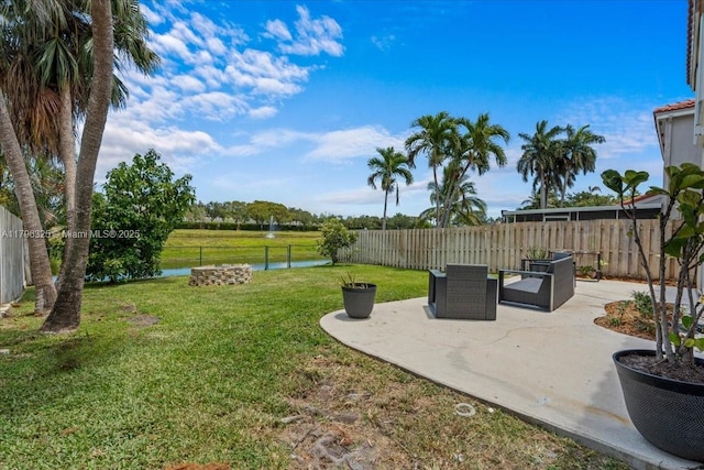 view of yard with a water view, a patio, and a fenced backyard