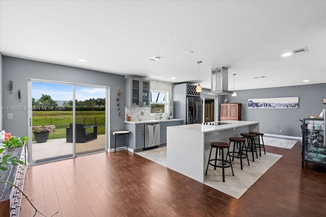 4370 SW 82nd Way, Davie, FL 33328 - kitchen with glass insert cabinets, island range hood, light wood-style floors, stainless steel appliances, and gray cabinets