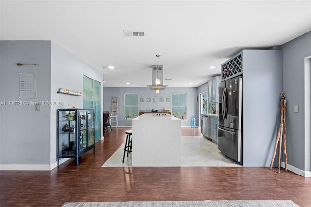 4370 SW 82nd Way, Davie, FL 33328 - kitchen featuring stainless steel appliances, decorative light fixtures, visible vents, a center island, and baseboards