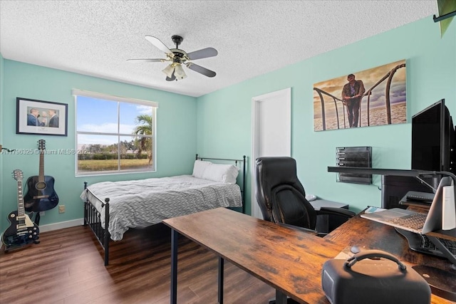 bedroom featuring baseboards, ceiling fan, a textured ceiling, and wood finished floors