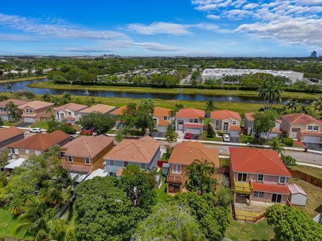 drone / aerial view with a water view and a residential view