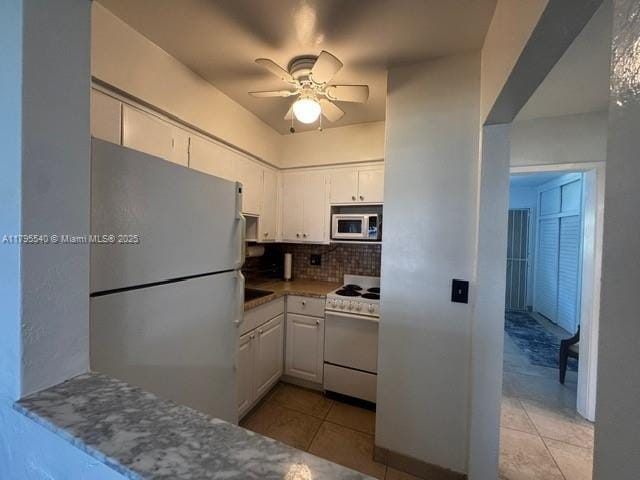 801 Atlantic Shores Blvd Unit 115, Hallandale Beach, FL 33009 - kitchen featuring freestanding refrigerator, white gas range, white cabinets, and ceiling fan