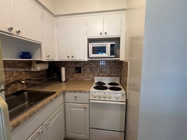 801 Atlantic Shores Blvd Unit 115, Hallandale Beach, FL 33009 - kitchen featuring white cabinetry, backsplash, white appliances, and a sink