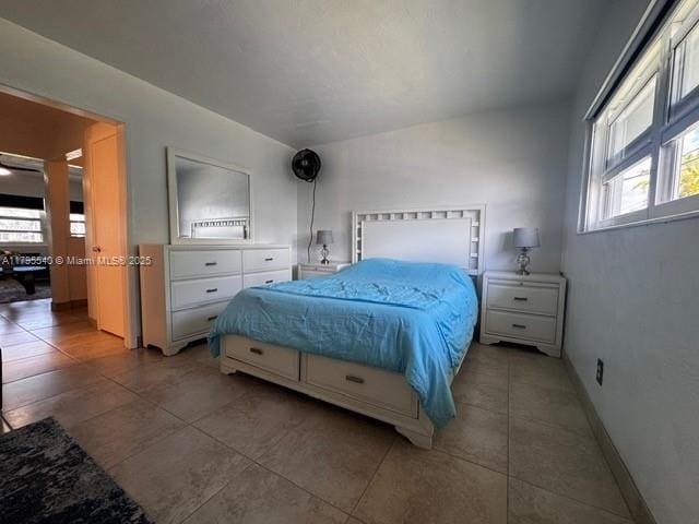 801 Atlantic Shores Blvd Unit 115, Hallandale Beach, FL 33009 - bedroom featuring baseboards and light tile patterned floors