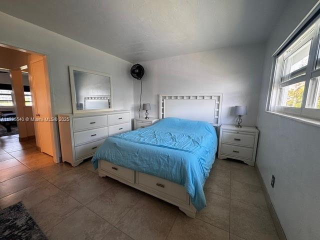801 Atlantic Shores Blvd Unit 115, Hallandale Beach, FL 33009 - bedroom with baseboards and tile patterned floors