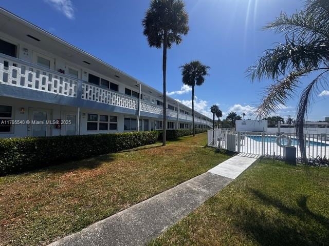 801 Atlantic Shores Blvd Unit 115, Hallandale Beach, FL 33009 - surrounding community with a pool and a yard