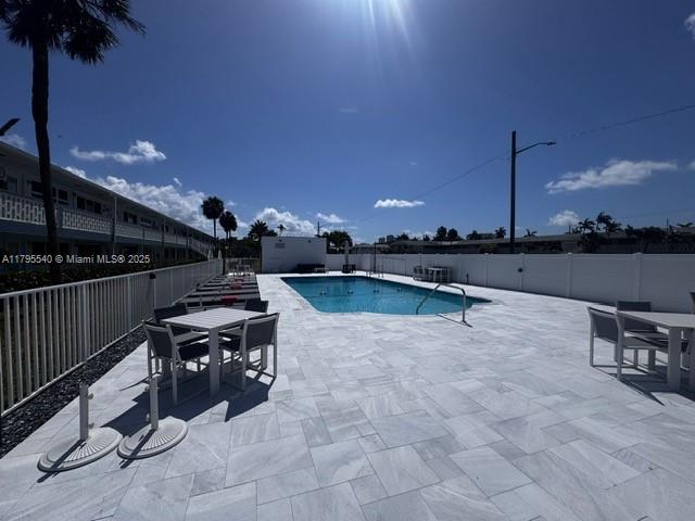 801 Atlantic Shores Blvd Unit 115, Hallandale Beach, FL 33009 - view of swimming pool with outdoor dining area, fence, and a patio area