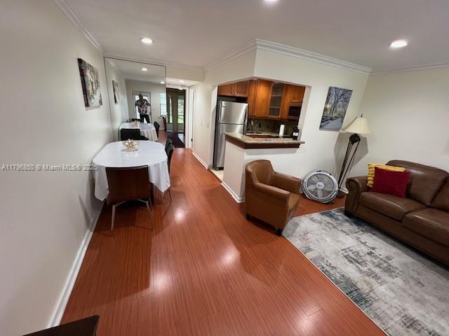 14 Westbury A 14, Deerfield Beach, FL 33442 - living area featuring ornamental molding, baseboards, and dark wood finished floors