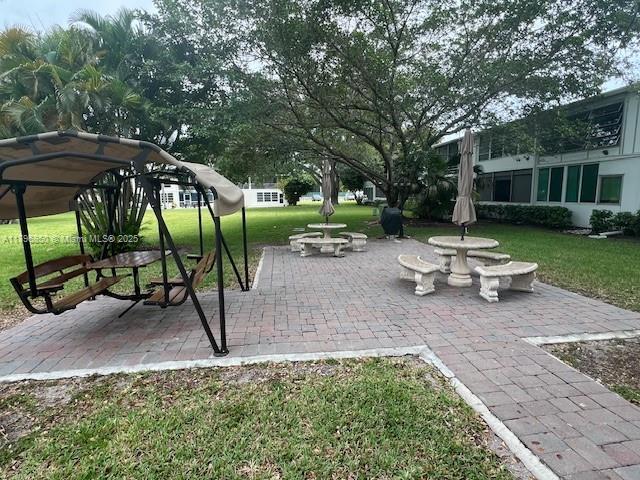 14 Westbury A 14, Deerfield Beach, FL 33442 - view of property's community featuring a patio area and a lawn