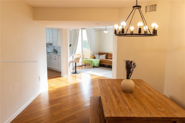 520 SE 5th Ave Unit 3302, Fort Lauderdale, FL 33301 - dining space with a chandelier, light wood finished floors, baseboards, and visible vents