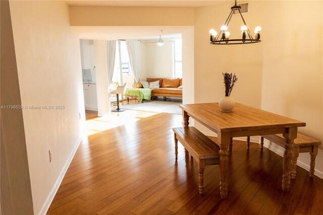 520 SE 5th Ave Unit 3302, Fort Lauderdale, FL 33301 - dining room featuring a chandelier, hardwood / wood-style flooring, and baseboards