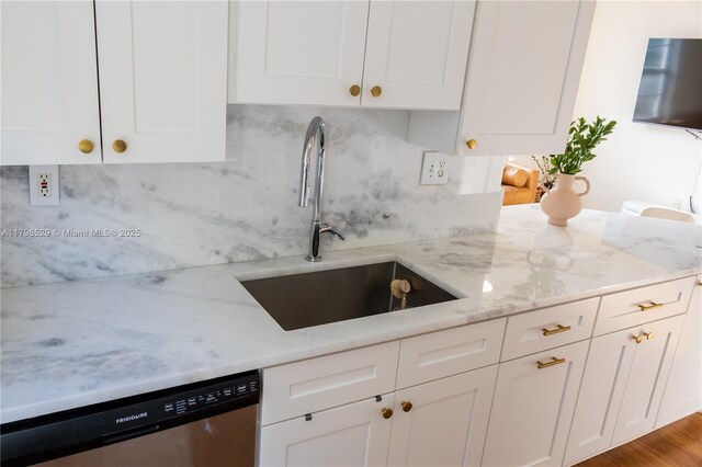 520 SE 5th Ave Unit 3302, Fort Lauderdale, FL 33301 - kitchen with a sink, white cabinets, stainless steel dishwasher, light stone countertops, and decorative backsplash