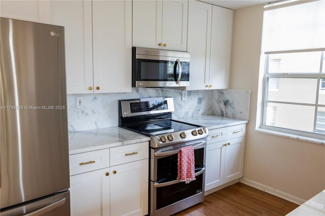 520 SE 5th Ave Unit 3302, Fort Lauderdale, FL 33301 - kitchen with wood finished floors, white cabinetry, decorative backsplash, and appliances with stainless steel finishes