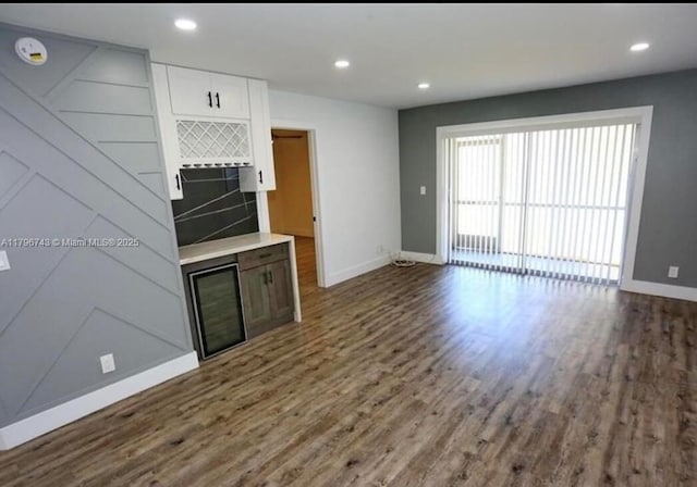 3688 N University Dr Unit H-3, Coral Springs, FL 33065 - kitchen featuring baseboards, dark wood finished floors, white cabinetry, open floor plan, and light countertops