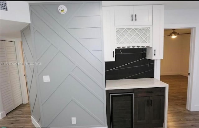 3688 N University Dr Unit H-3, Coral Springs, FL 33065 - kitchen featuring white cabinetry, baseboards, light stone counters, and wood finished floors