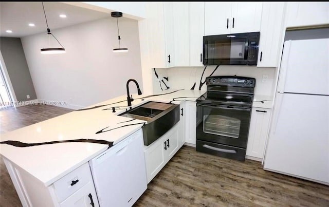 3688 N University Dr Unit H-3, Coral Springs, FL 33065 - kitchen featuring a peninsula, dark wood finished floors, white cabinetry, black appliances, and light countertops