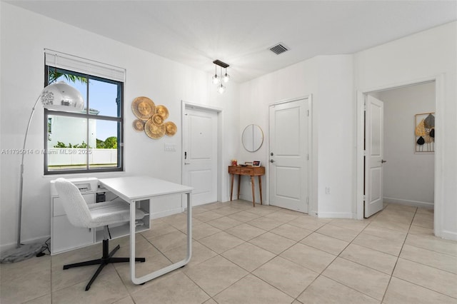 office with baseboards, light tile patterned floors, and visible vents