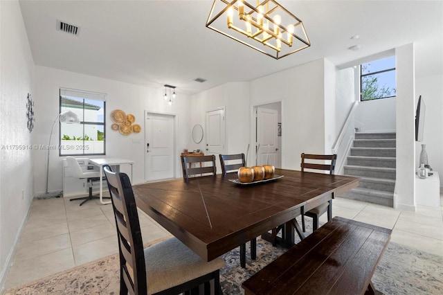 dining room with light tile patterned floors, a healthy amount of sunlight, and visible vents