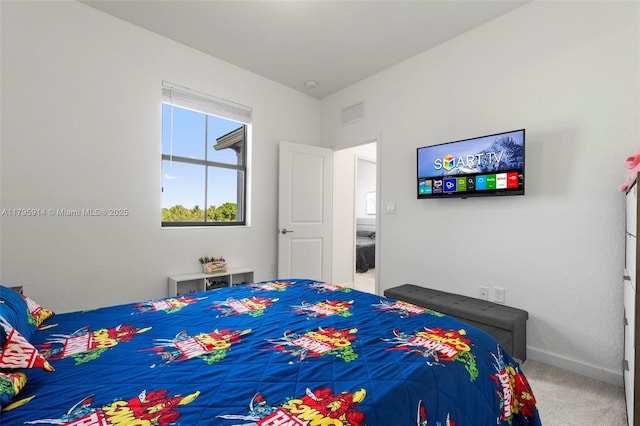 carpeted bedroom with baseboards and visible vents