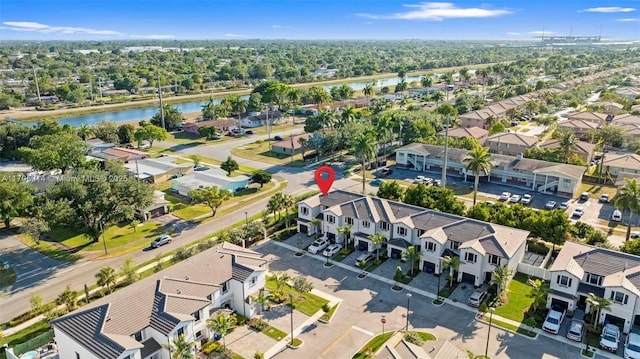 birds eye view of property with a water view and a residential view