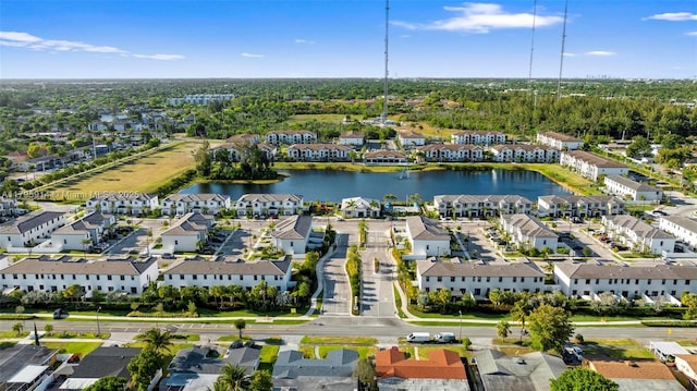 drone / aerial view with a water view and a residential view