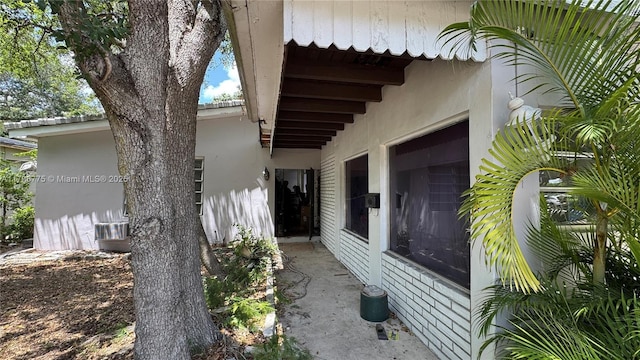 view of side of home with stucco siding