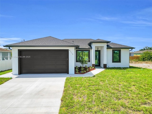 4115 20th St SW, Lehigh Acres, FL 33397 - prairie-style house featuring driveway, fence, a garage, stucco siding, and a front yard