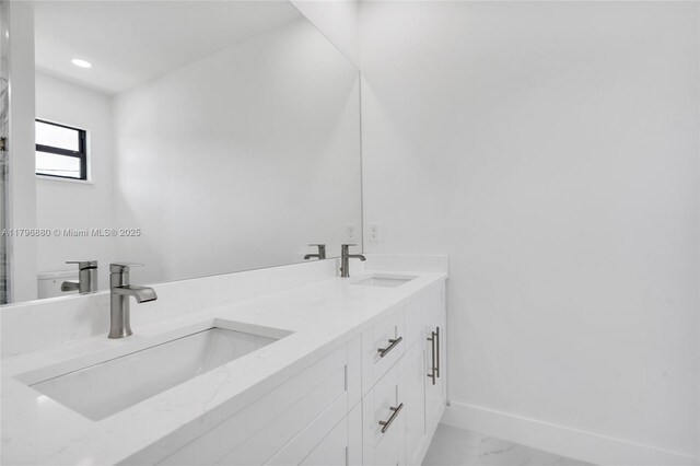 4115 20th St SW, Lehigh Acres, FL 33397 - full bath with a sink, double vanity, baseboards, and marble finish floor