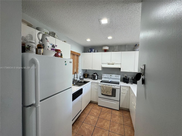 kitchen with under cabinet range hood, white appliances, a sink, light countertops, and white cabinets