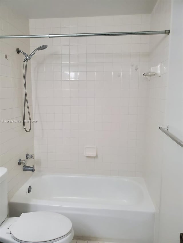 bathroom with toilet and bathing tub / shower combination