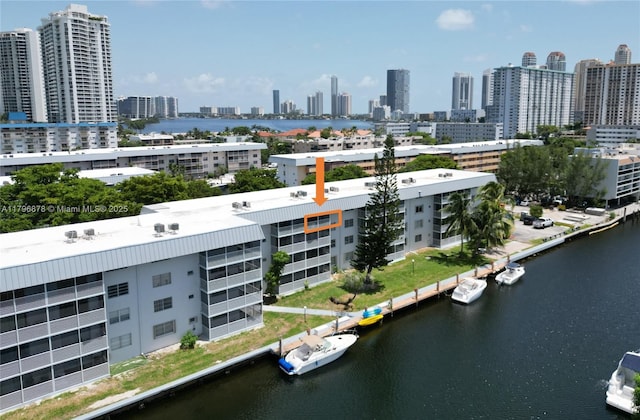 aerial view featuring a city view and a water view