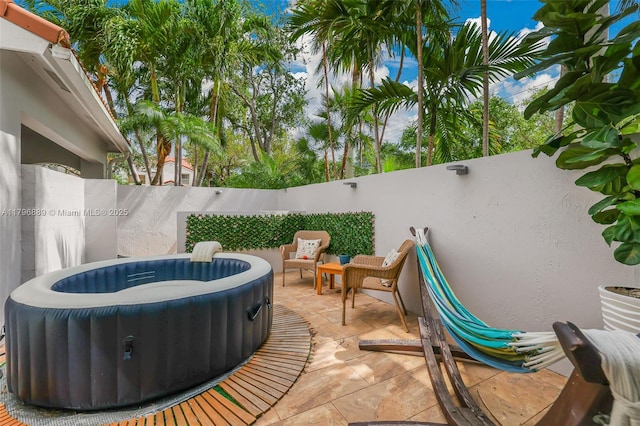 1110 Canella Ln, Hollywood, FL 33019 - view of patio / terrace with a hot tub and a fenced backyard