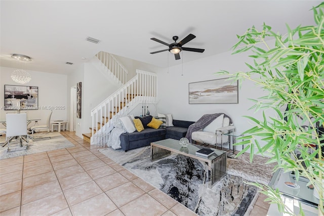 1110 Canella Ln, Hollywood, FL 33019 - tiled living room with visible vents, ceiling fan with notable chandelier, and stairs