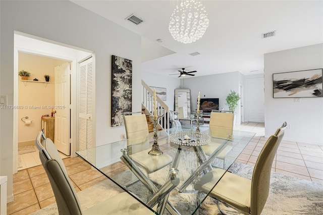 1110 Canella Ln, Hollywood, FL 33019 - dining area featuring light tile patterned flooring, visible vents, ceiling fan with notable chandelier, and stairs