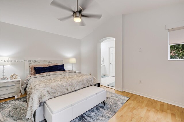 1110 Canella Ln, Hollywood, FL 33019 - bedroom featuring light wood finished floors, a ceiling fan, baseboards, arched walkways, and vaulted ceiling