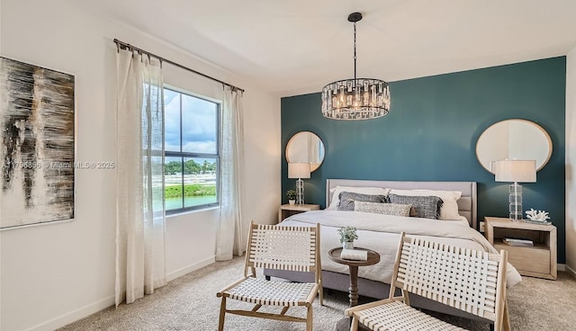 carpeted bedroom featuring a chandelier and baseboards
