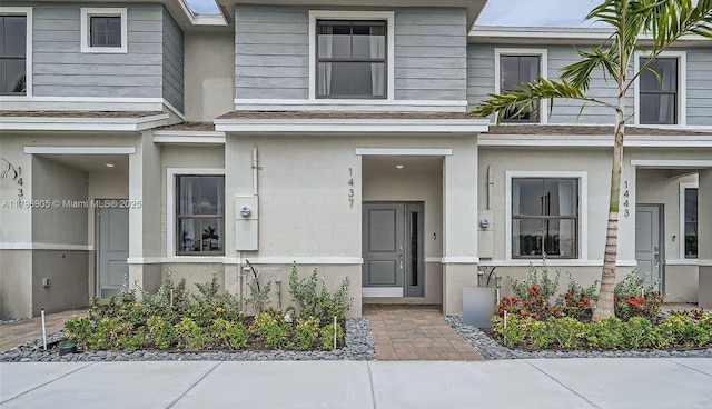 doorway to property featuring stucco siding