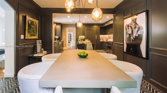 dining space featuring recessed lighting, ornamental molding, and arched walkways